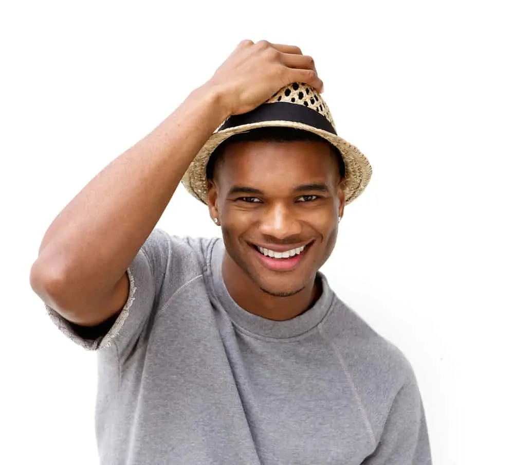 7 Best Edgers for Black Hair: Top Hair Clippers & Hair Edgers 8 Utilizing a professional-grade trimmer with a precision bevel trimmer and adjustable t-shaped blade, this skilled man expertly trimmed his sensitive skin and ear hair, demonstrating his understanding of the delicate and precise nature of hair grooming.