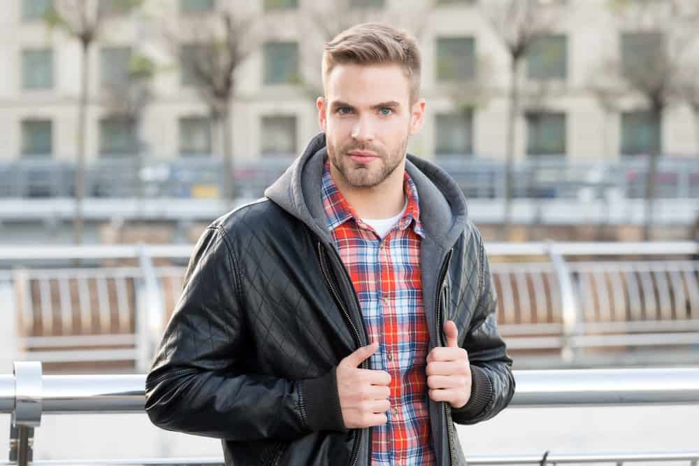 The high fade haircut draws attention upwards, diverting the gaze from his forehead and showcasing his stylish sense of fashion.