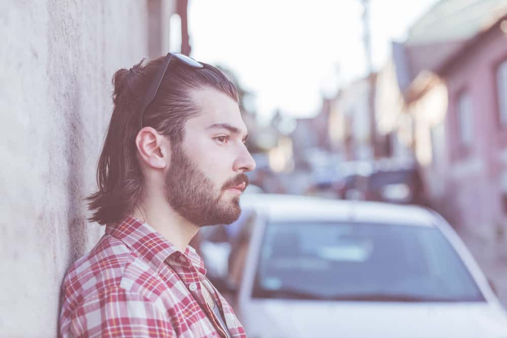 The guy's square box-shaped Mexican mullet perfectly complements his oval face shape, creating a balanced and stylish, perfect look.