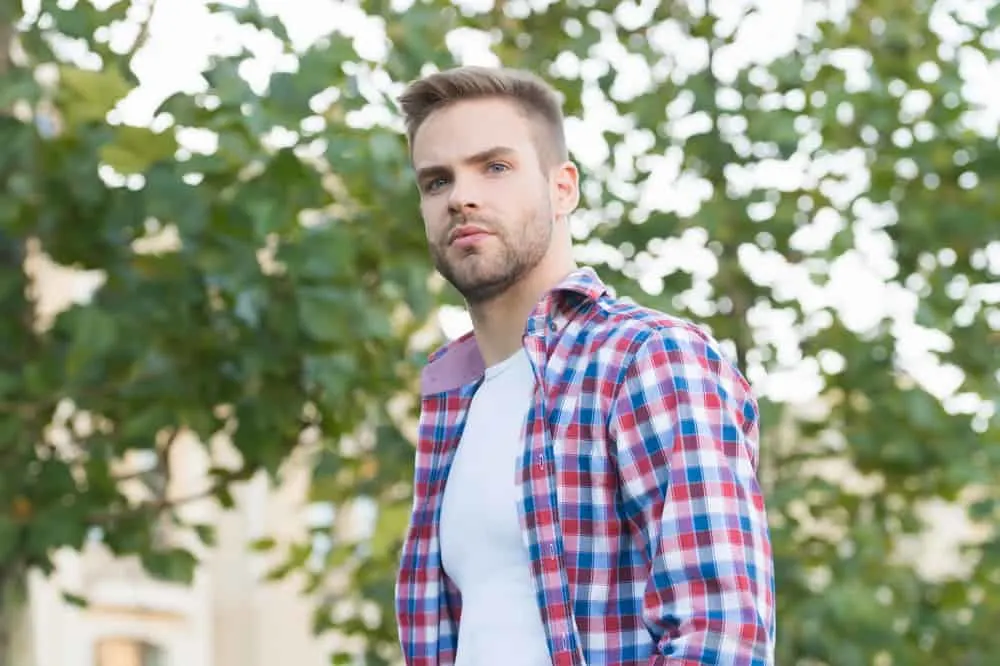 Hairstyles for Men with Big Foreheads: Step-by-Step Tutorials 11 The French crop haircut, with its short length and textured top, gives him a modern and trendy appearance.
