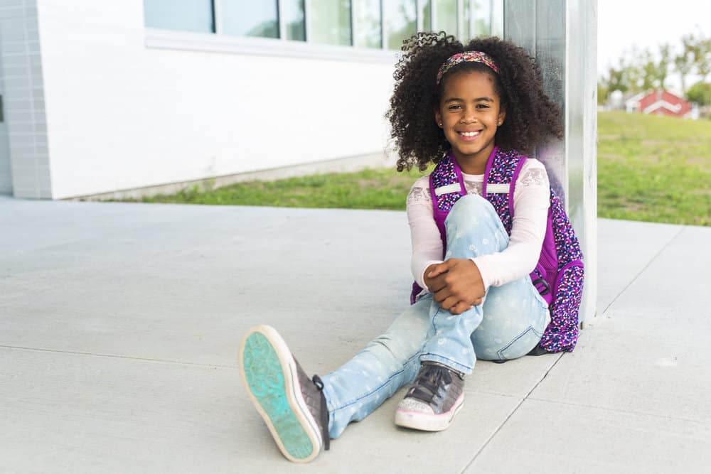 The cute young black girl rocks one of our most popular natural hairstyles - a wash-n-go,  showcasing an age-appropriate and stylish hairstyle.