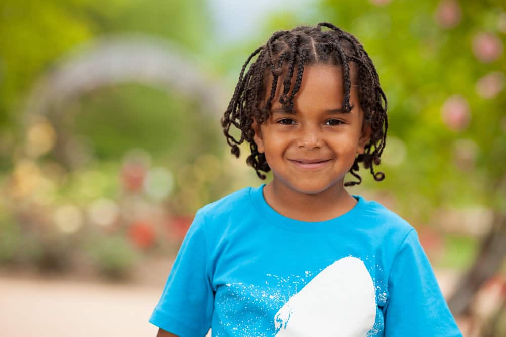 With thicker braids created in a zig-zag pattern, the adorable toddler showcases a unique and funky braid style that complements his natural black hair.