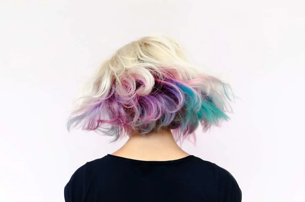 8 Underdye Hair Coloring Trends, Ideas, and Hairstyle Tips 2 The guy's short Mexican mullet haircut adds an edgy and daring touch to his thick, straight hair, accentuating his oval face shape.