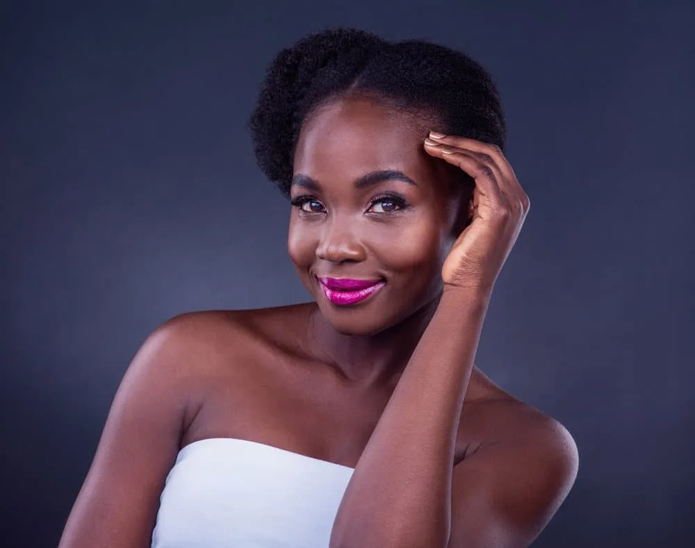 How to Seal Moisture in Hair: Moisturizing & Sealing Your Hair 4 A gorgeous black girl with type 4 natural hair showcases the importance of sealing moisture in the hair shaft with light sealing oils, like olive or peppermint oil.