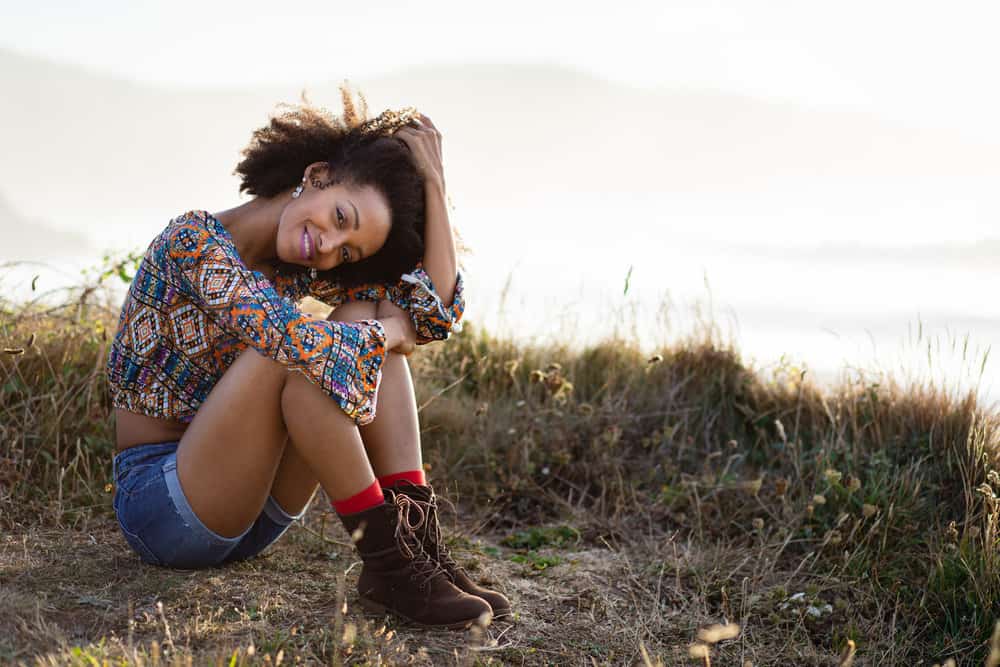 The beautiful black woman embraces neem oil as a natural and holistic approach to hair care, reaping its benefits for healthier, shinier, and more vibrant hair.