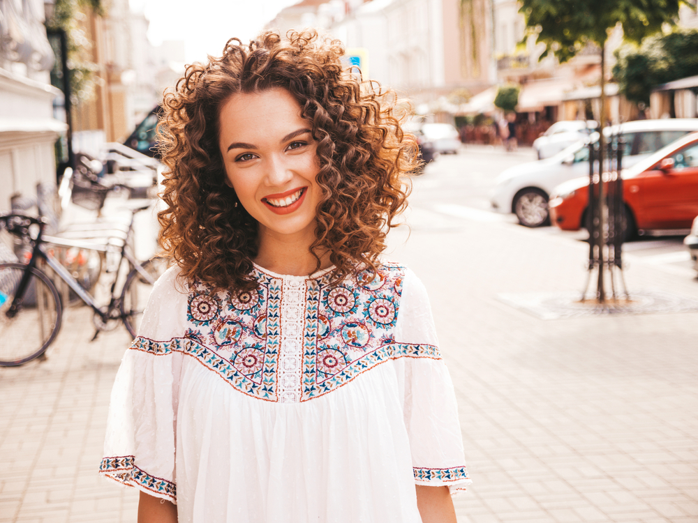 With her Caucasian hair expertly treated, the lady radiates charm and allure, her digital perm enhancing her natural beauty.