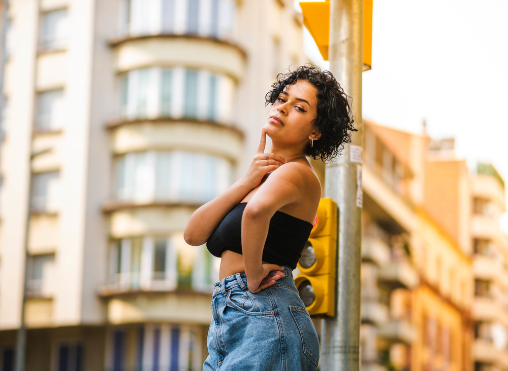 The young woman's bisexual bob, edging dangerously close to her jaw level, accentuates her facial features and adds a touch of boldness to her long hair.