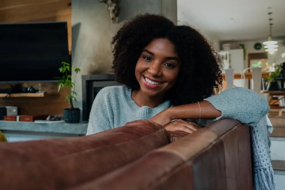 How to Cut Curly Hair: Cutting Hair at Home for Curly Girls 2 A beautiful African American female with bouncy individual curls on her naturally wavy tresses.