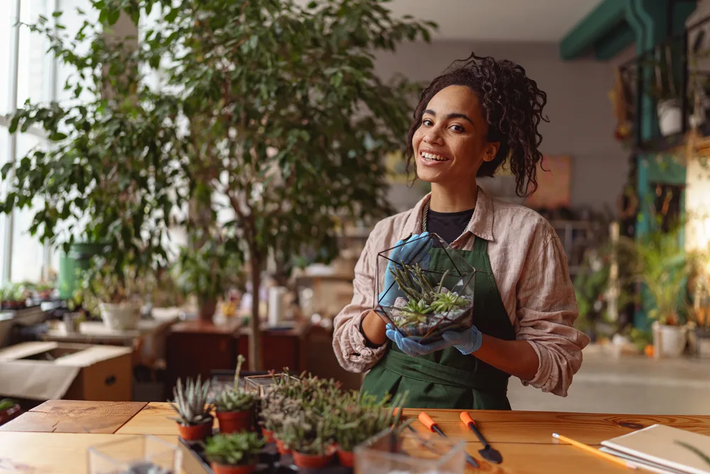 African Herbs for Hair Growth: Herbal Methods from Africa 1 A young African American woman with an aloe vera plant that she'll use to promote hair growth and smooth an irritated scalp.