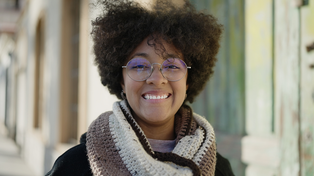 Embracing the benefits of raw shea butter, this woman's curly hairdo showcases the power of essential fatty acids in maintaining strong and beautiful hair.