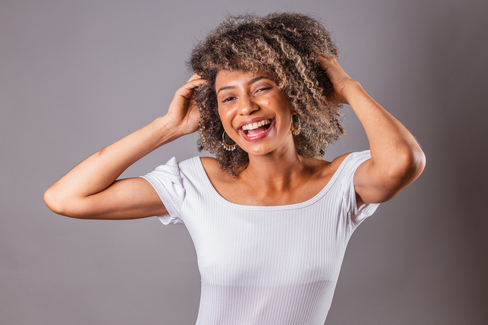 The soap nuts' fine powder acts as a mild cleanser, gently removing impurities from her hair, scalp, and sensitive skin.