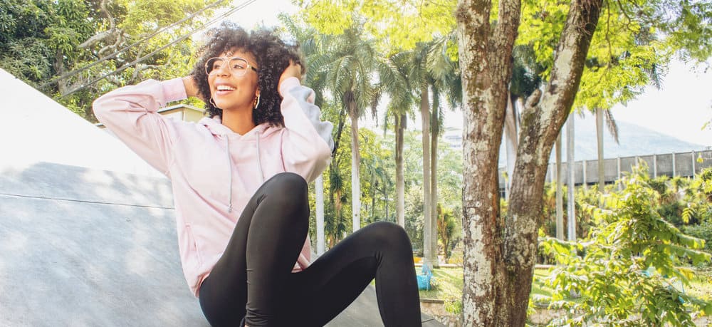 With her wet curls glistening, this black girl's natural hair takes center stage, displaying the healthy and defined curls she adorns.