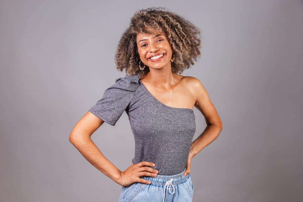 This cute black girl knows the importance of clean hair and uses an organic shampoo and conditioner treatment to keep her dirty hair fresh.