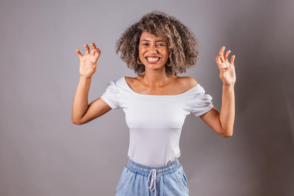 To maintain her scalp's health, she sprays a diluted peppermint essential oil mixture on her hair roots.