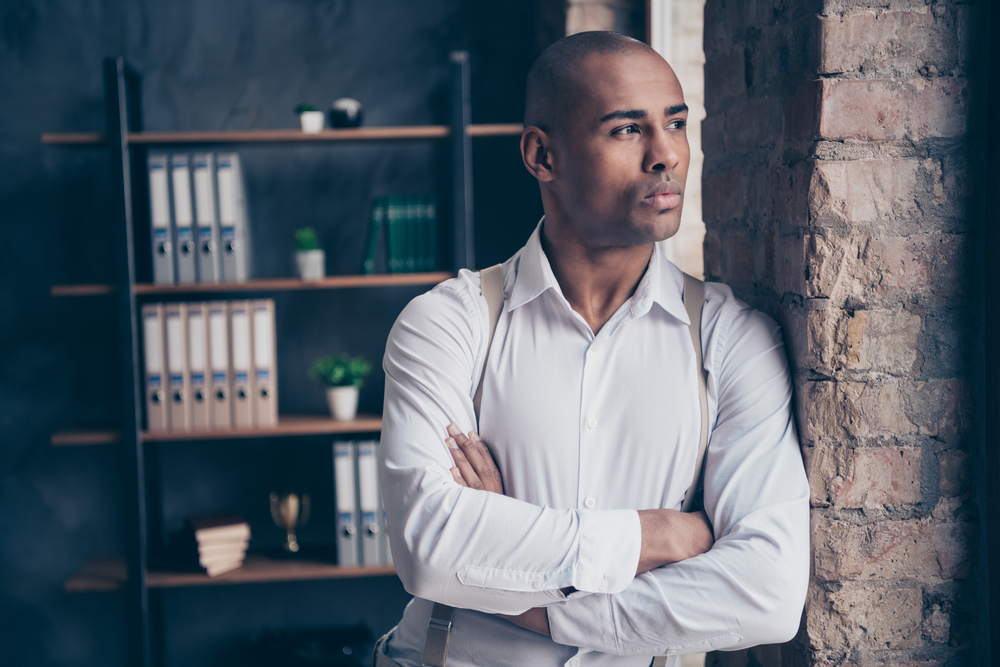 With confidence in his eyes, this black gentleman expertly wields the best hair clippers to achieve a flawless haircut while caring for his sensitive skin and preventing razor bumps.