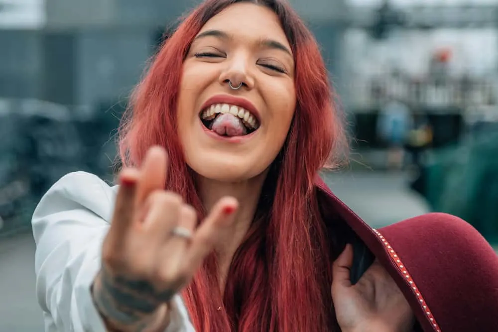 Aesthetic E-Girl Hair: Color Ideas, Hairstyles, and Haircuts 19 Chunky face framing highlights in pink give her e-girl hairstyle a bold and playful edge.
