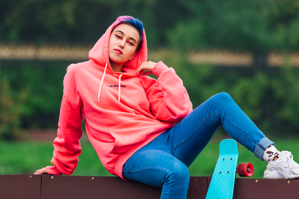 This cute young girl rocks a gender-neutral pixie bowl cut, showcasing her confidence and embracing her unique sense of style.