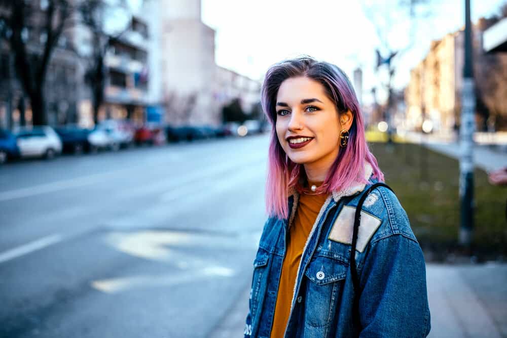 This beautiful white girl embraces her creativity with purple dye covering her naturally brown hair with a light purple hair shade.