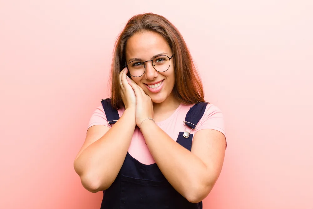 How to Grow and Style Waist Length Hair: Step-By-Step Guide 7 Styling her hair in a half ponytail allows her to showcase the length and natural texture of her locks.