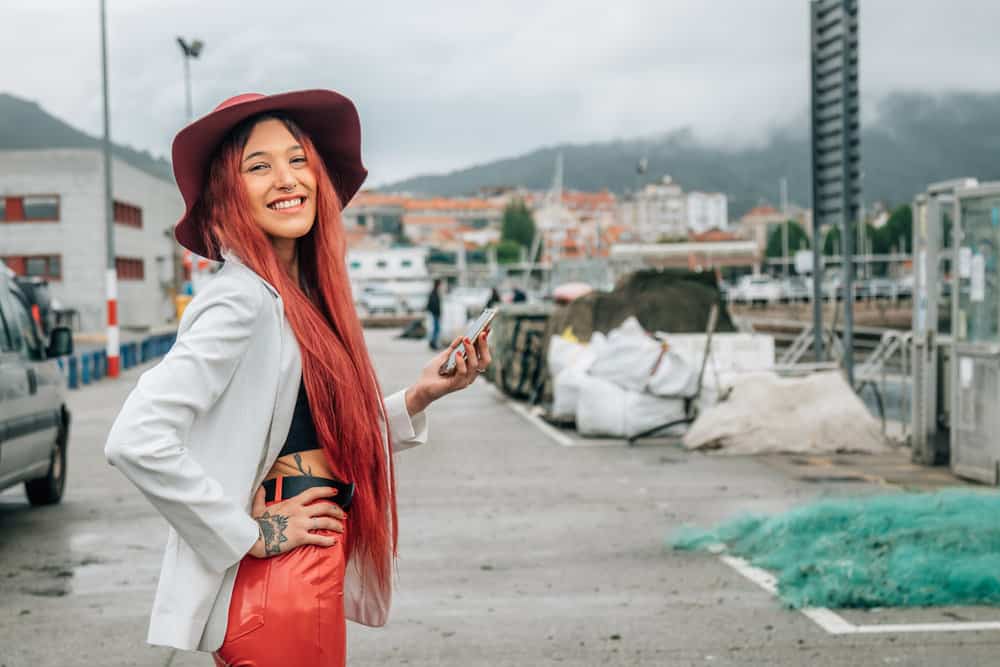 Jet black hair serves as the perfect canvas for her e-girl makeup and colorful hair accessories.