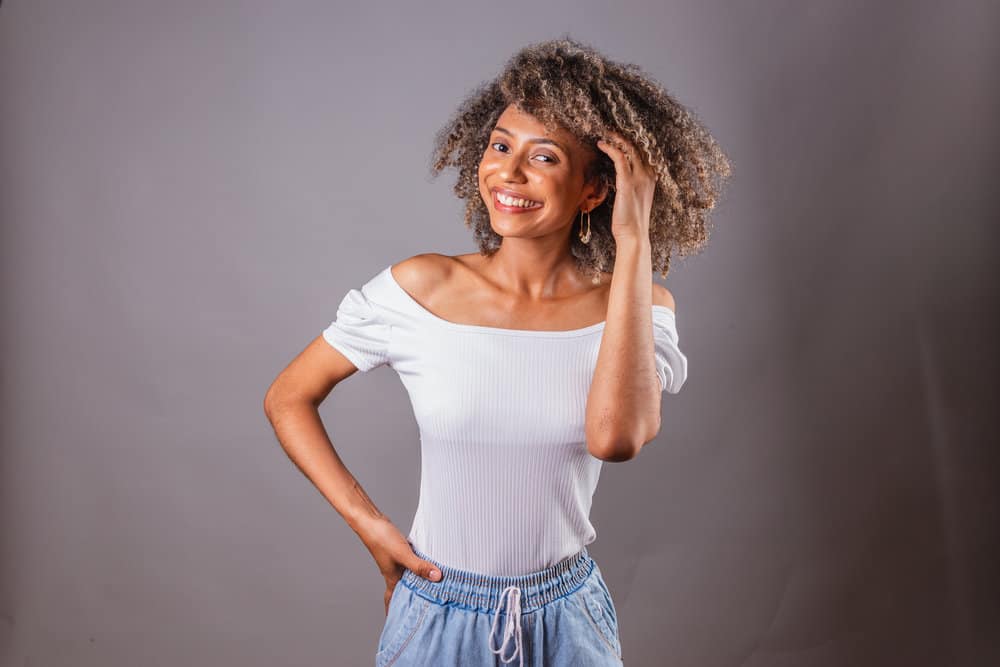 Her hair glistens with health as she cleanses it with a homemade soap nut shampoo made from organic soap nuts.