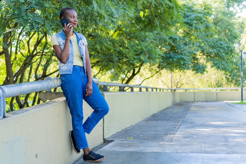 The young African American woman embraces her thinning hair in a fresh youthful bob haircut, exuding confidence and allure.