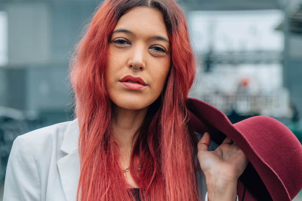 Her hair clips are carefully chosen to match her colorful hair, adding an extra touch of personality to her style.