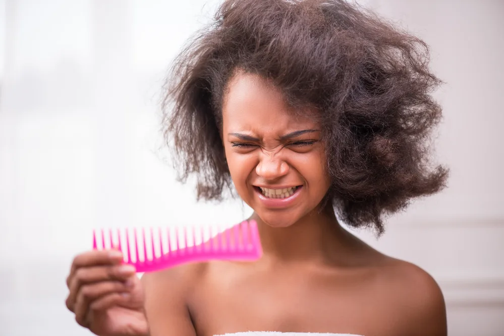 Fixing Tangled and Severely Matted Hair After Hospital Stay 3 The matted hair extensions in her afro-textured hair require extra care and patience to untangle without causing damage.