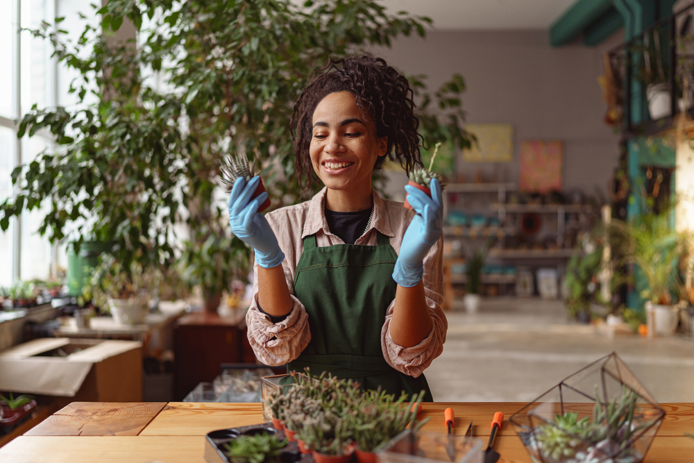 With the aloe vera plant in her hand, she embraces the power of nature for stimulating hair growth and nourishing hair treatments.