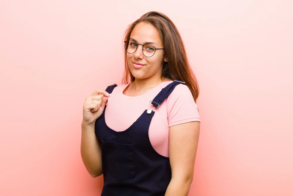 How to Grow and Style Waist Length Hair: Step-By-Step Guide 1 A beautiful white girl with waist-length curly hair enhanced with straight hair extensions before being styled with a curling iron and loose ends.