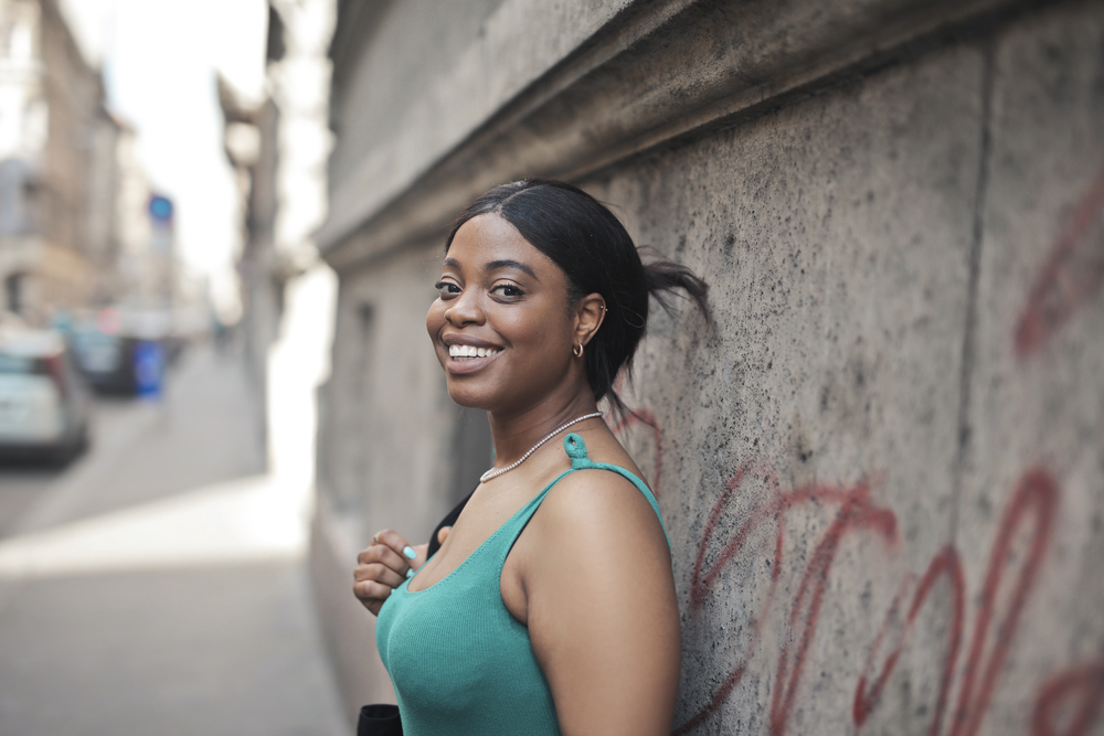 With her great smile, she confidently rocks a lace closure wig that seamlessly blends with her natural hairline.