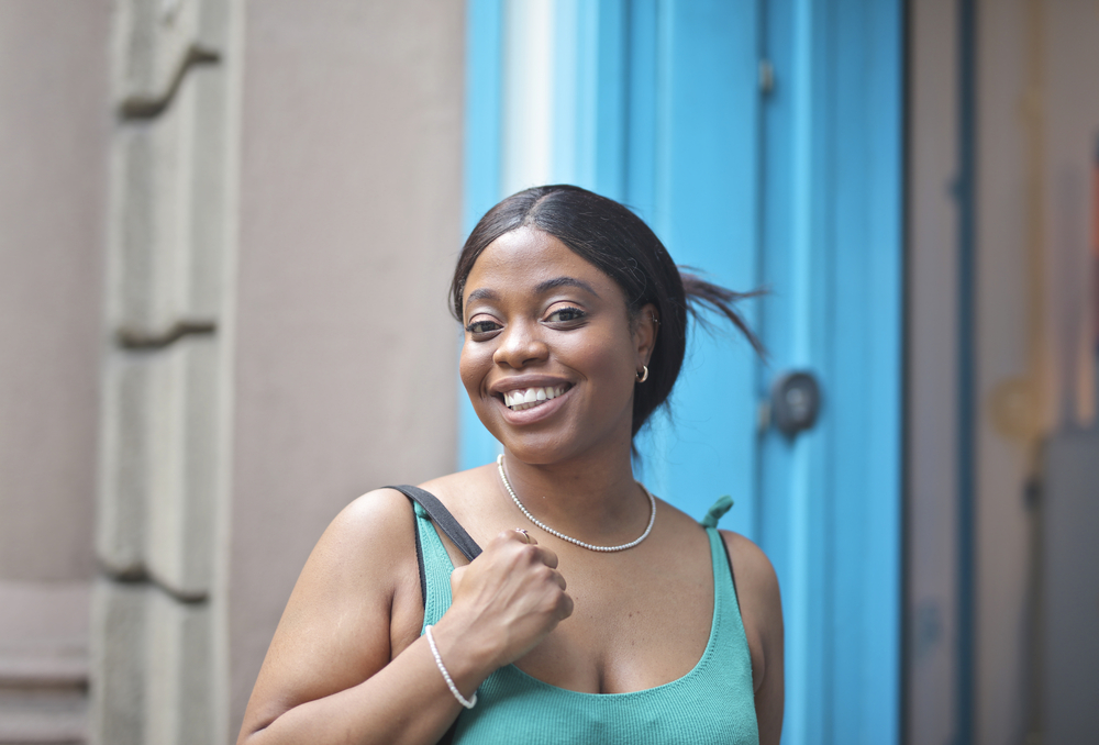 The lace closure wig she's wearing beautifully enhances her natural hair texture, creating a slightly wavy, thicker look.