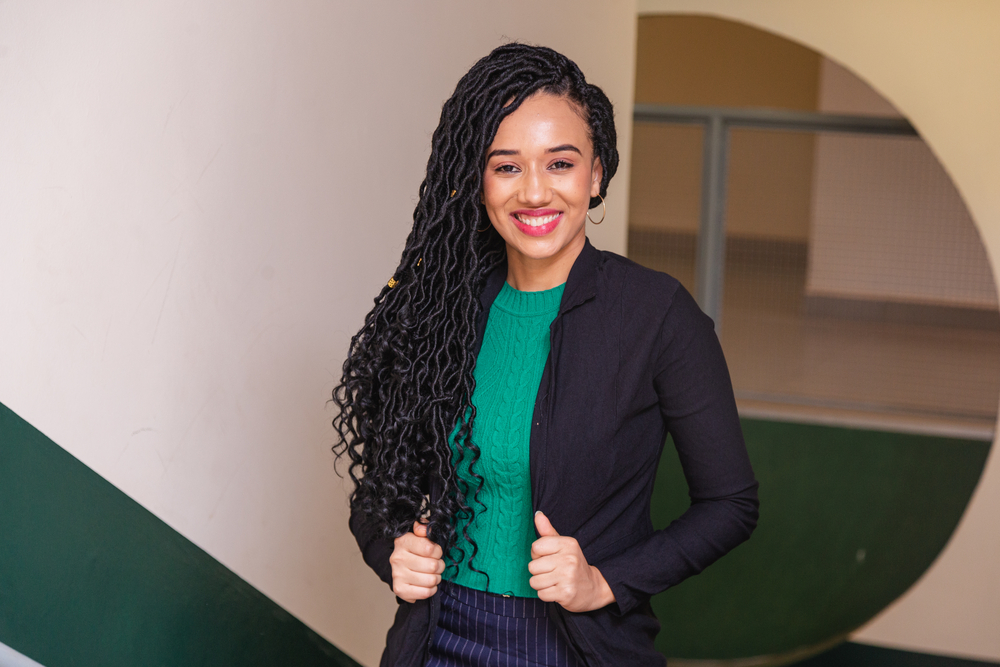 A young black woman wearing micro braids that are all the rage in the natural hair community due to their modern take on a braided hairstyle.