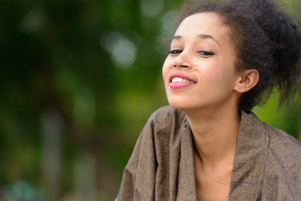 The use of claw clips, snap clips, and banana clips as hair accessories adds flair and style to her updo, accentuating the beauty of her kinky hair.