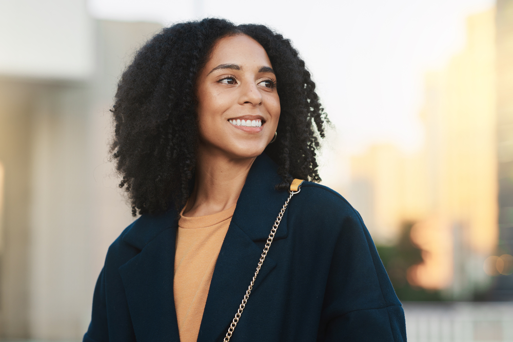 Following styling tips from a celebrity hairstylist, she uses a crochet needle to create perfect ringlets that accentuate her natural waves.