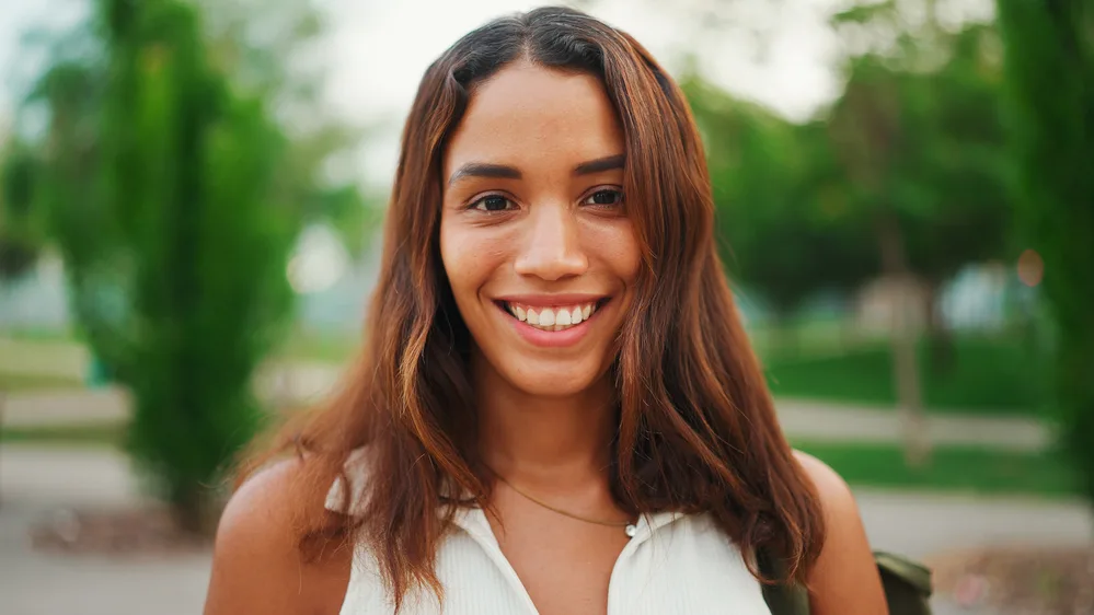 Hair Color Wheel: The Key to Perfect the Color of Your Hair 1 A beautiful girl with orange hair with cool tones that include hints of her dark brown natural hair color. The color matches perfectly with her brassy yellow tones.