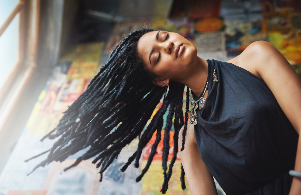 The beautiful black woman showcases the beauty of different hair lengths by wearing wavy hair extensions, from short strands to longer locks.