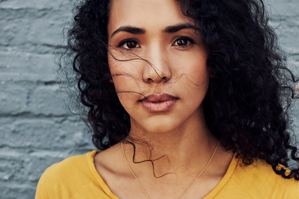 As she styles her curly and coily hair, she takes into consideration her unique hair type to achieve the desired look.