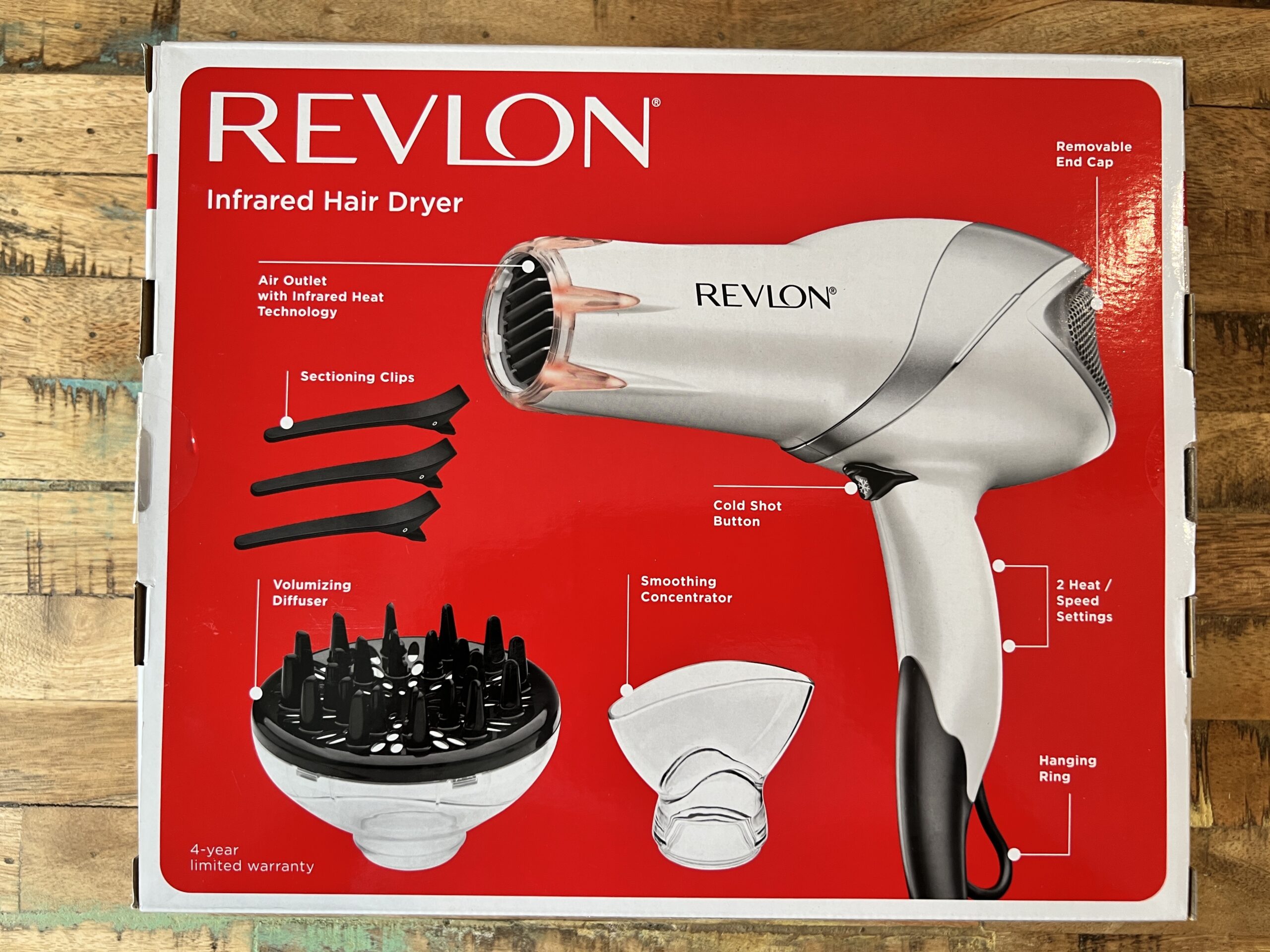 The Revlon infrared hair dryer box contents include the dryer, sectioning clips, volumizing diffuser, and smoothing concentrator.