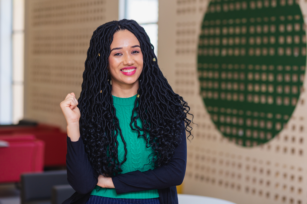 Embracing the natural hair movement, she wears her long hair in micro braids, a favorite go-to style in the natural hair community that includes several cute hairstyles.