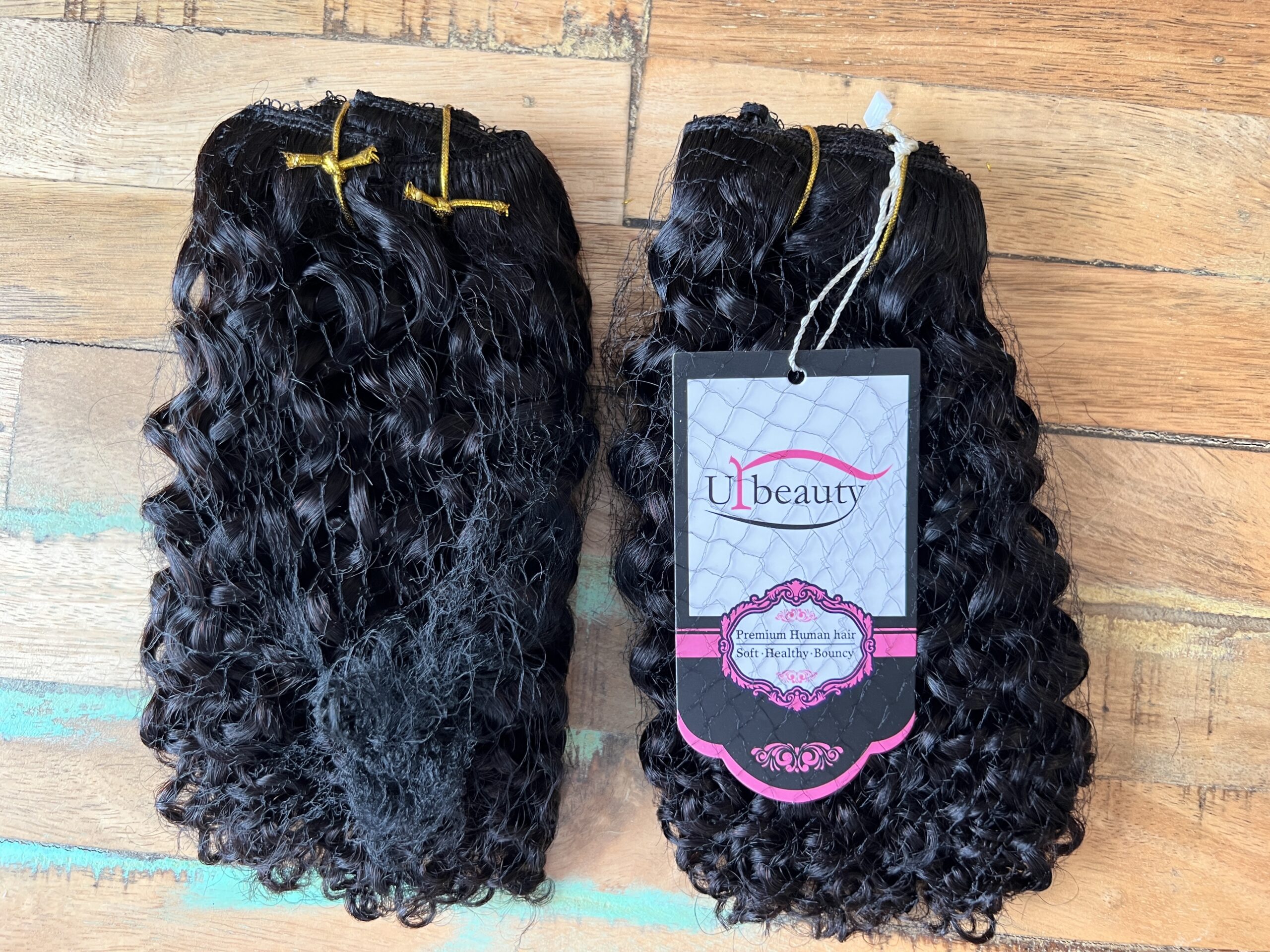 Soft, healthy, and bouncy UrBeauty premium human hair strands with corkscrew curls.