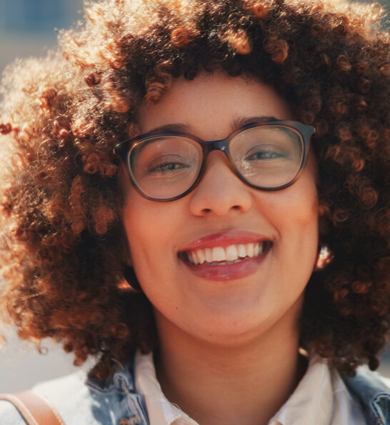 A cute African American female with dry hair styled with essential oils, like Jamaican castor oil and sunflower oil.