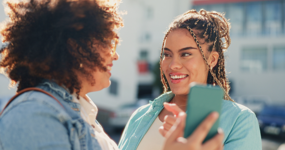 Two best friends discussing their personal hair goals and healthy growth routines for sensitive skin and scalp health.