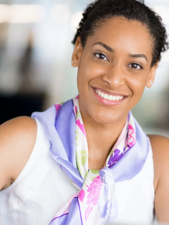 A young black woman with beautiful curls has been experiencing hair growth by using a simple hair care regimen with aloe vera gel, hair wax, and natural oils (e.g., coconut oil).