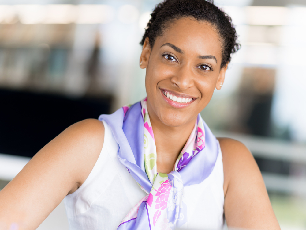 A young black woman with beautiful curls has been experiencing hair growth by using a simple hair care regimen with aloe vera gel, hair wax, and natural oils (e.g., coconut oil).