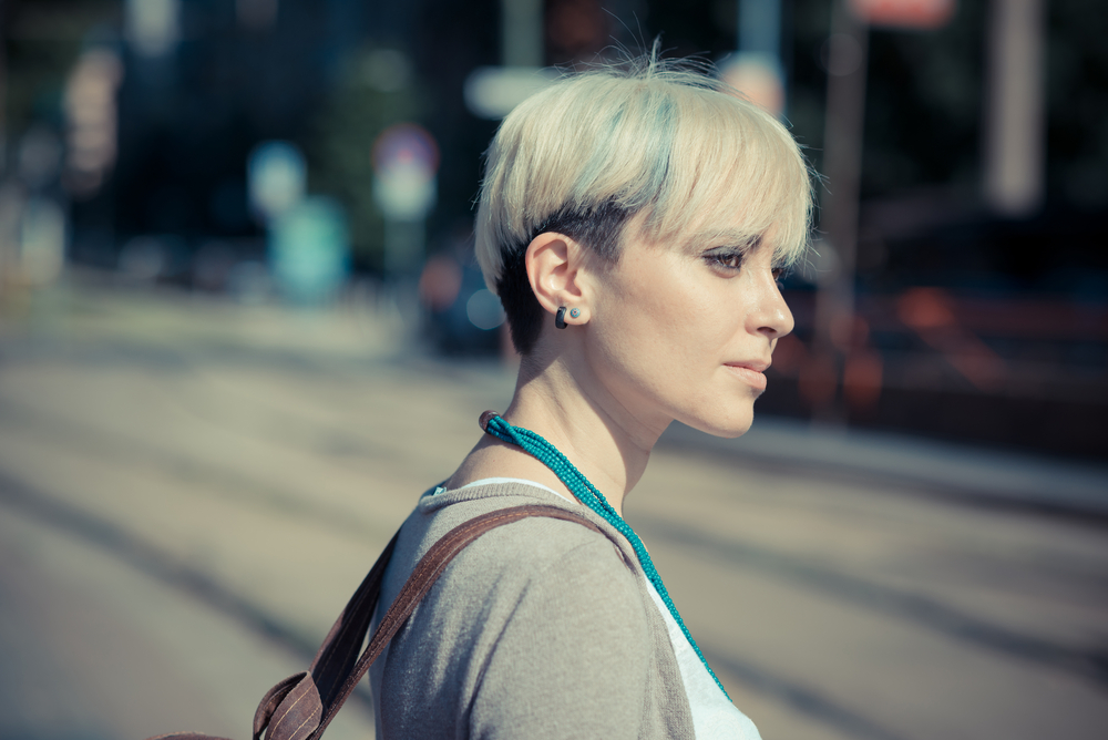 A young blonde female wearing an ear length Pixie cut hairstyle.