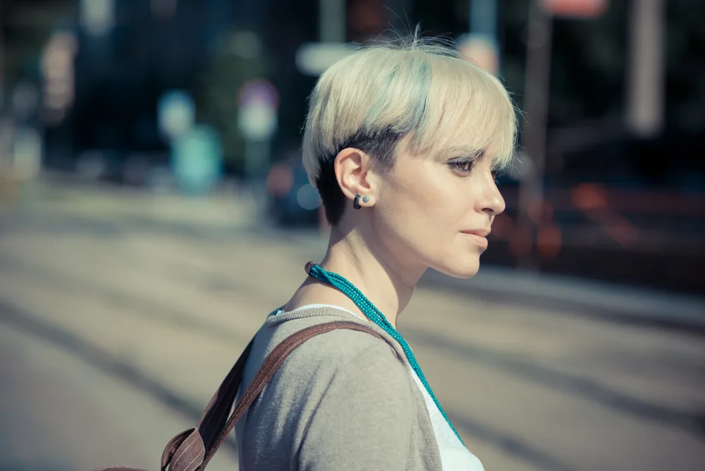Hair Length Chart: The Roadmap to Your Desired Hair Length 6 A young blonde female wearing an ear length Pixie cut hairstyle.