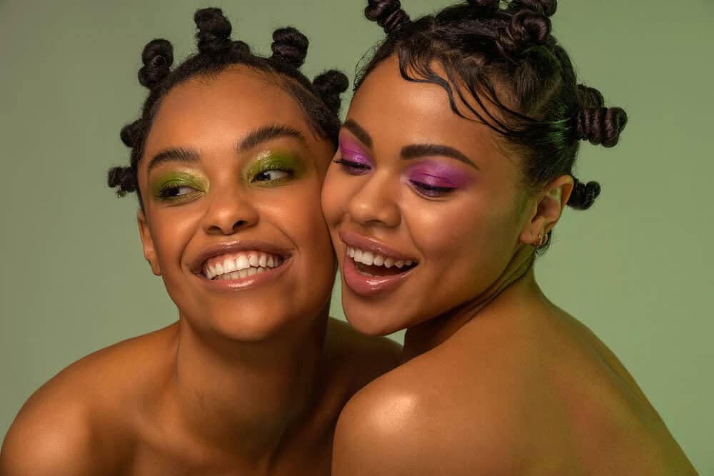 Two beautiful black girls converted their two-strand twist hairstyle into small knots. 