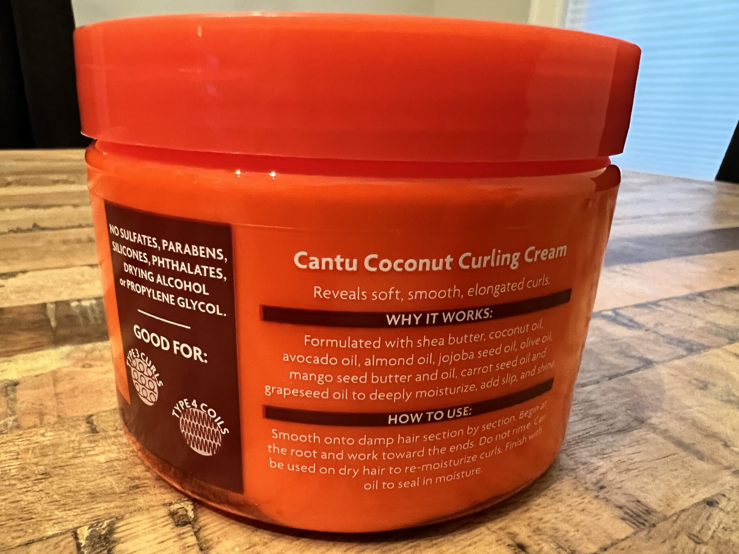 Back of Cantu Coconut Curling Cream packaging showing why it works and how to use it for type 3 curls and type 4 coils.