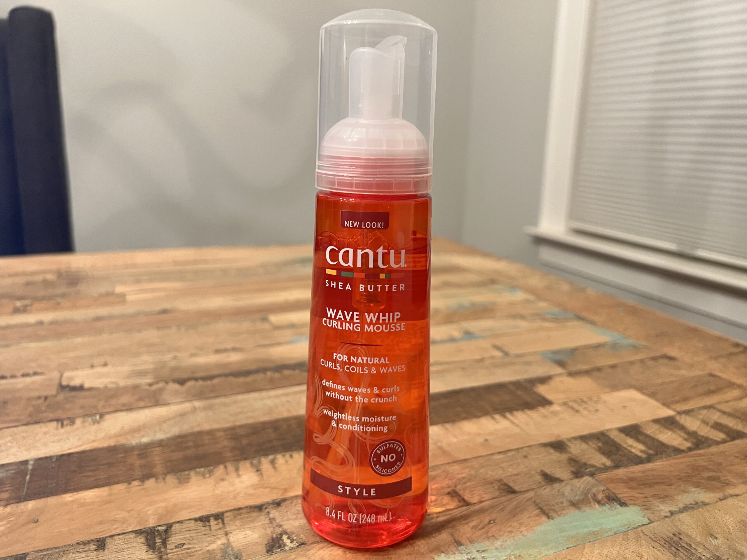 Cantu Shea Butter Wave Whip Curling Mousse can, formulated to define and enhance natural curl patterns.
